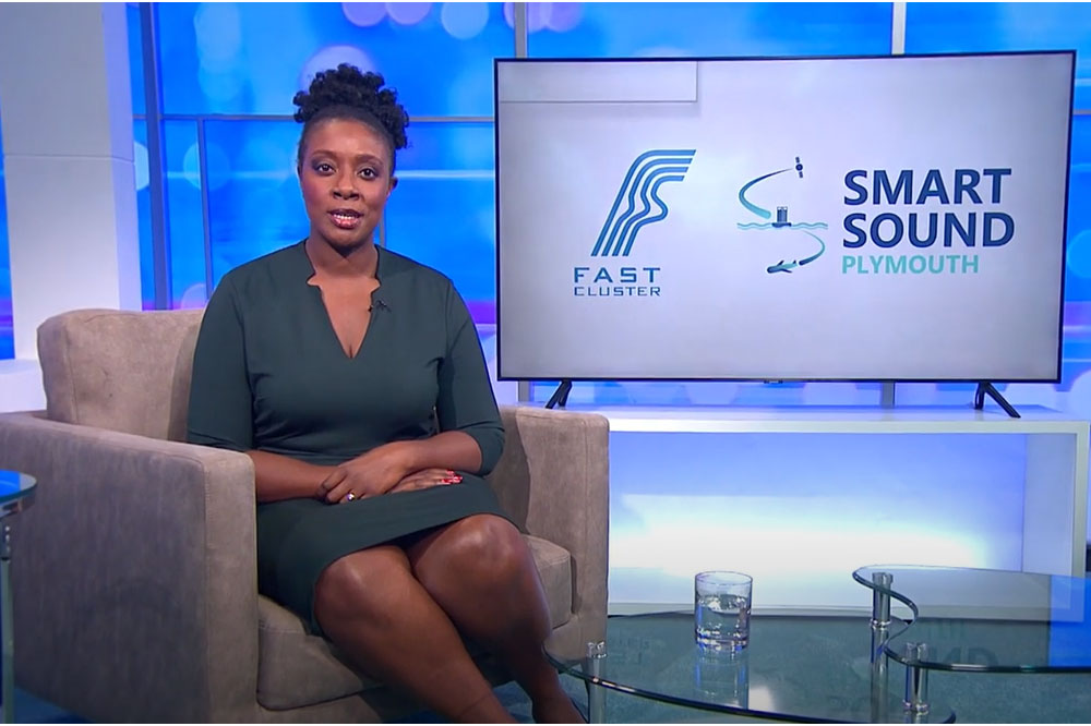 Screen shot from video showing presenter in studio with tv behind showing fast cluster and smartsound logos