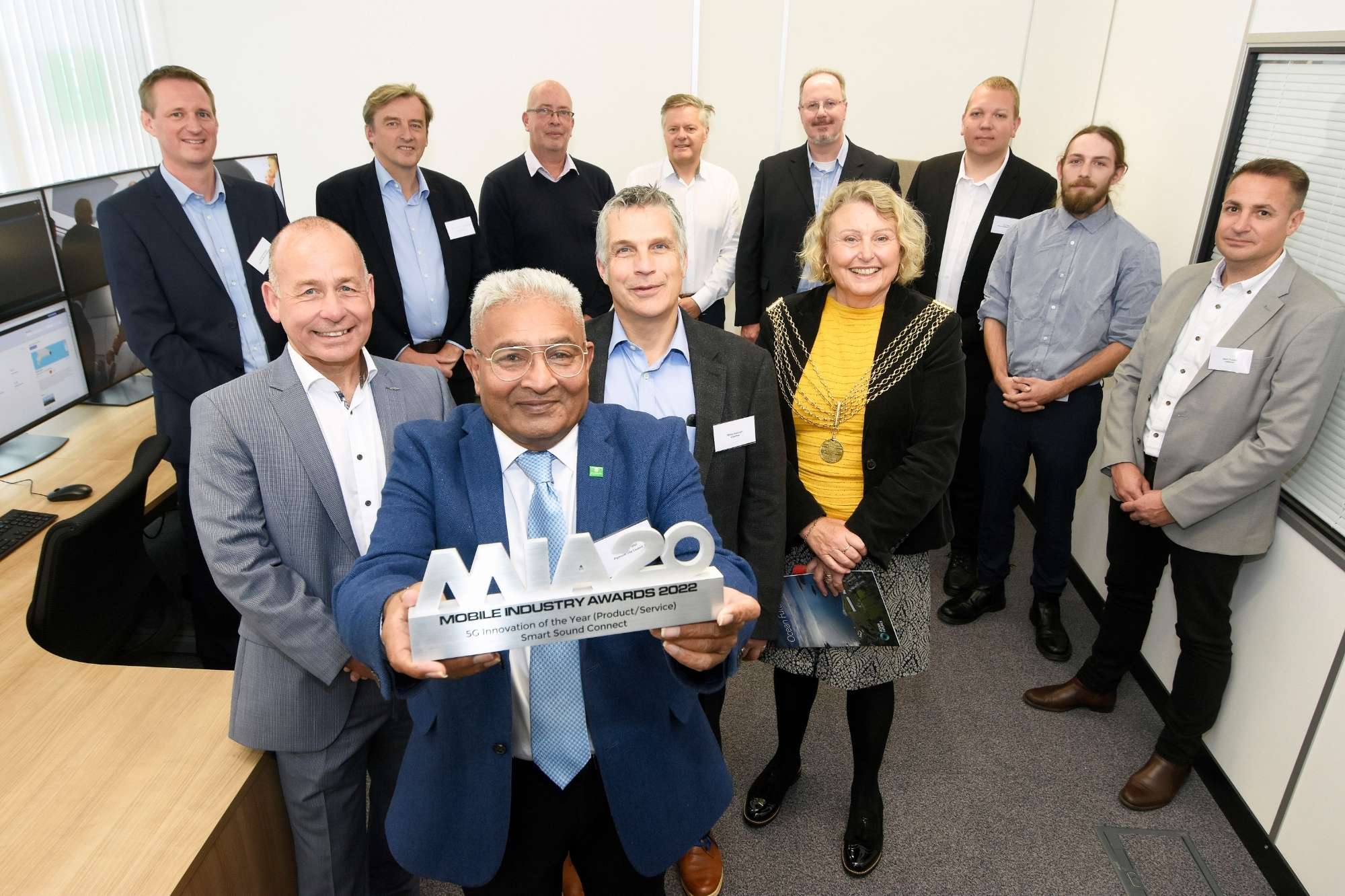 Invitees at the opening with Councillor Pat Patel holding the recent Mobile Industry award given to Smart Sound Connect for 5G innovation of the Year